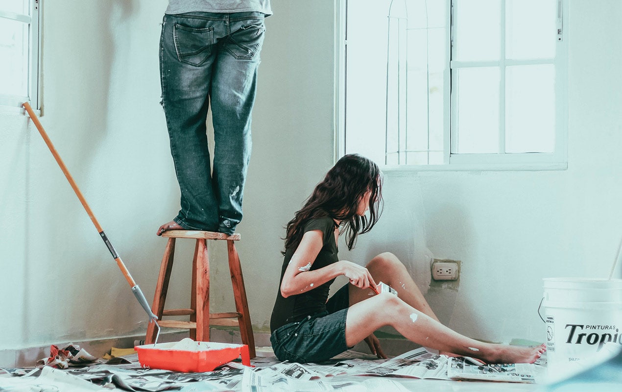 A man and woman painting and decorating
