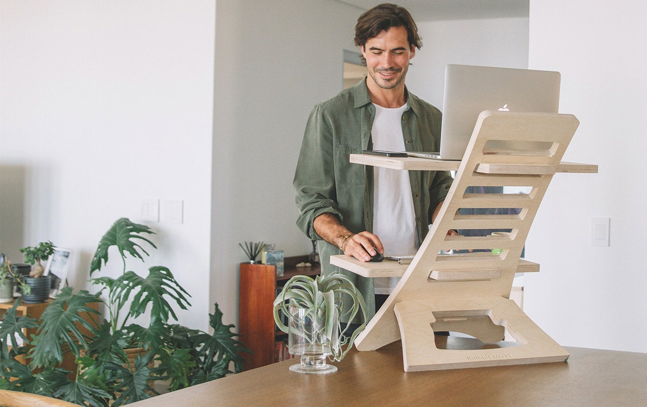 A man working from a standing desk