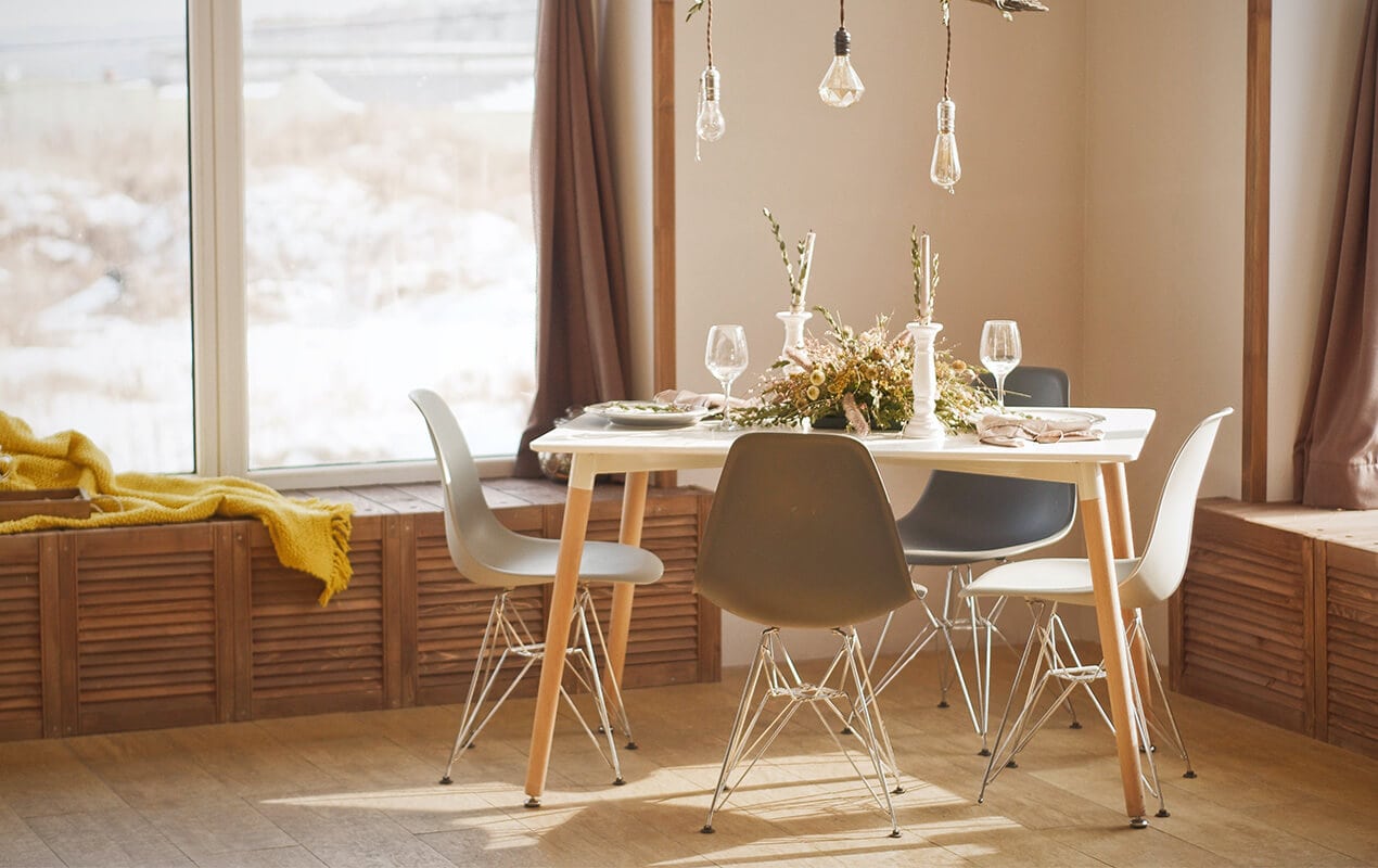 Small Dining table and chairs with lights and plant decor