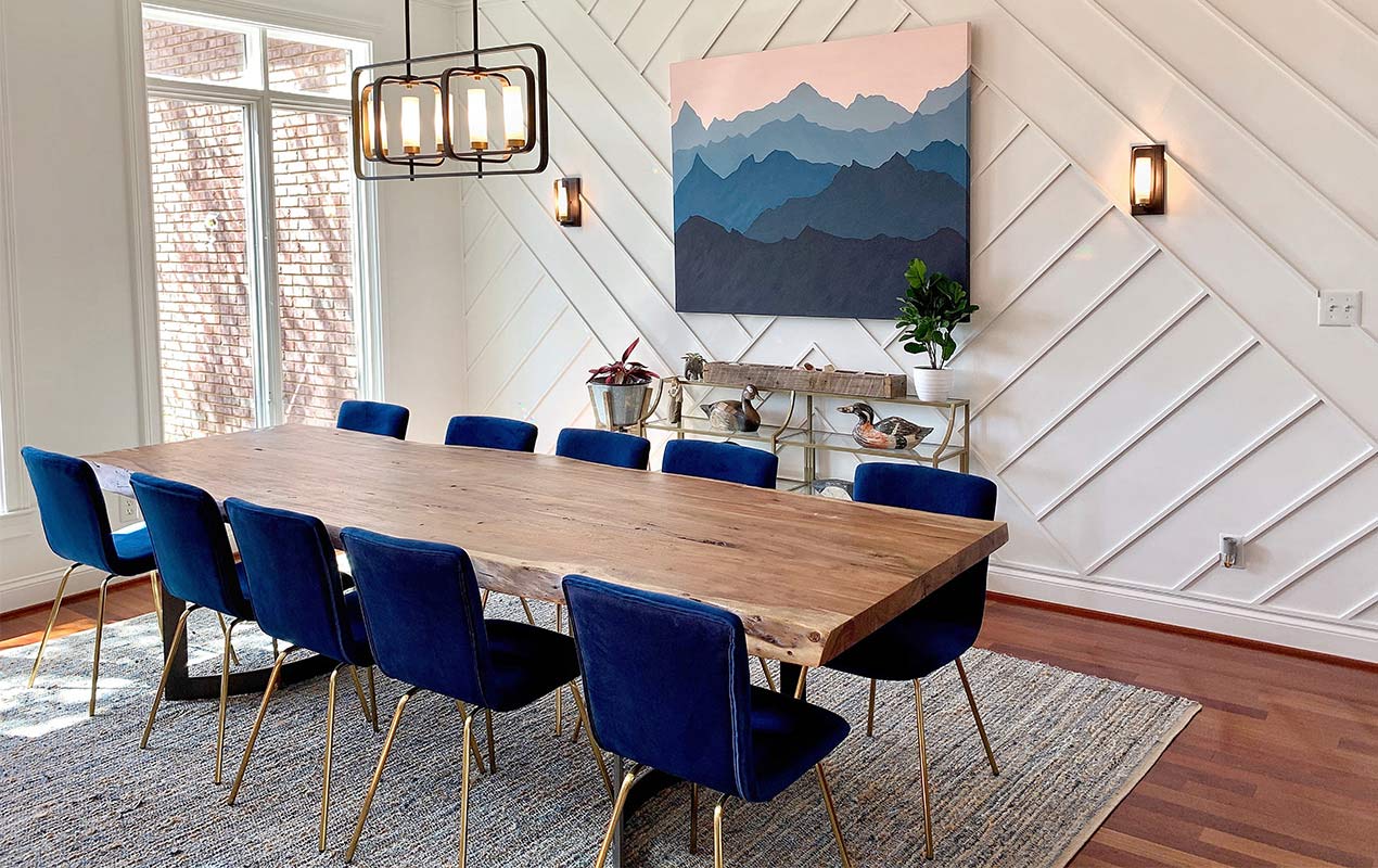 Dining room with a patterned wall, wall art, and lighting