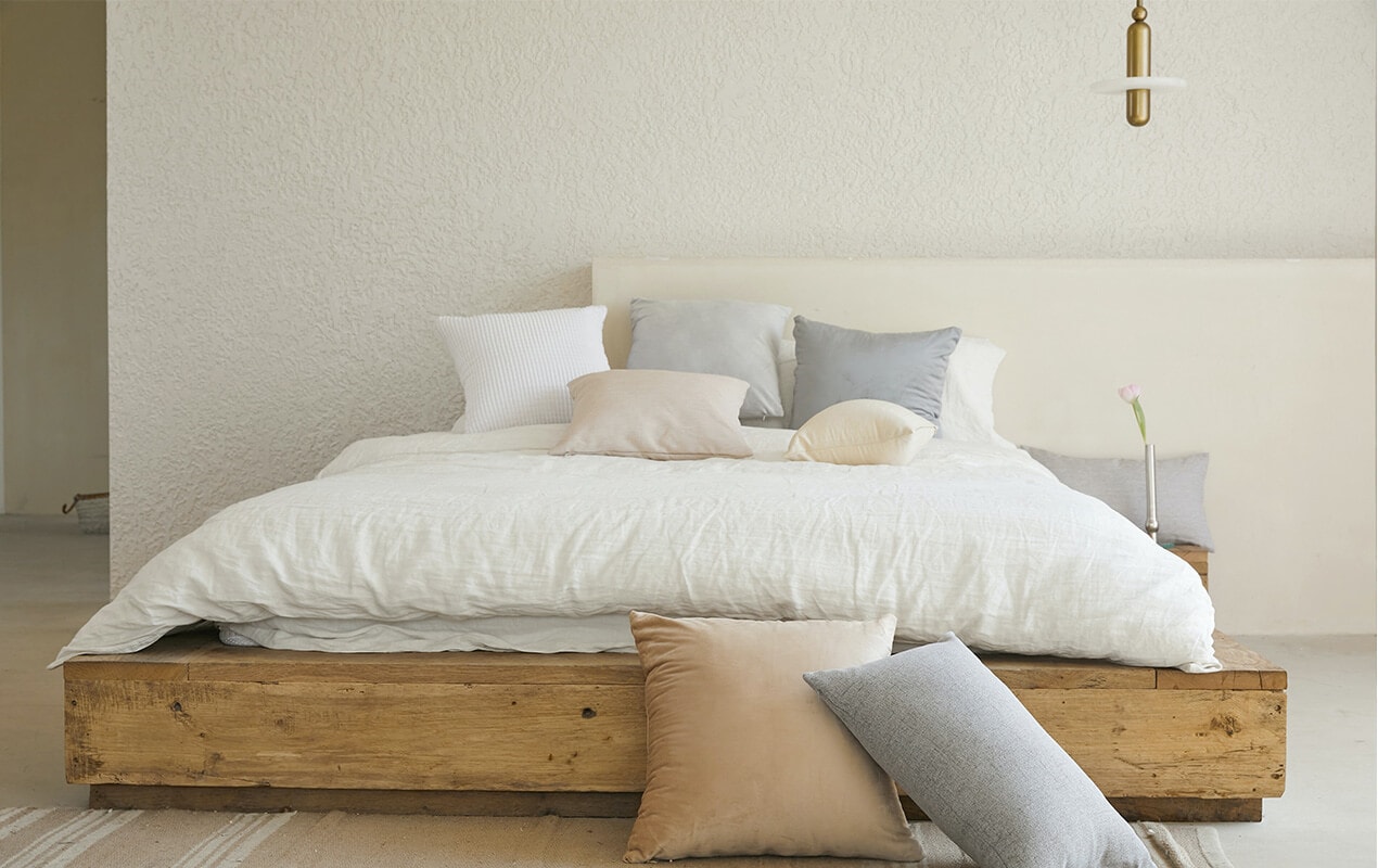 https://www.decasacollections.com/wp-content/uploads/2022/09/How-to-Do-Minimalist-Decor-in-2022-1st-image-Bedroom-with-minimal-decor-bed-and-cushions.jpg