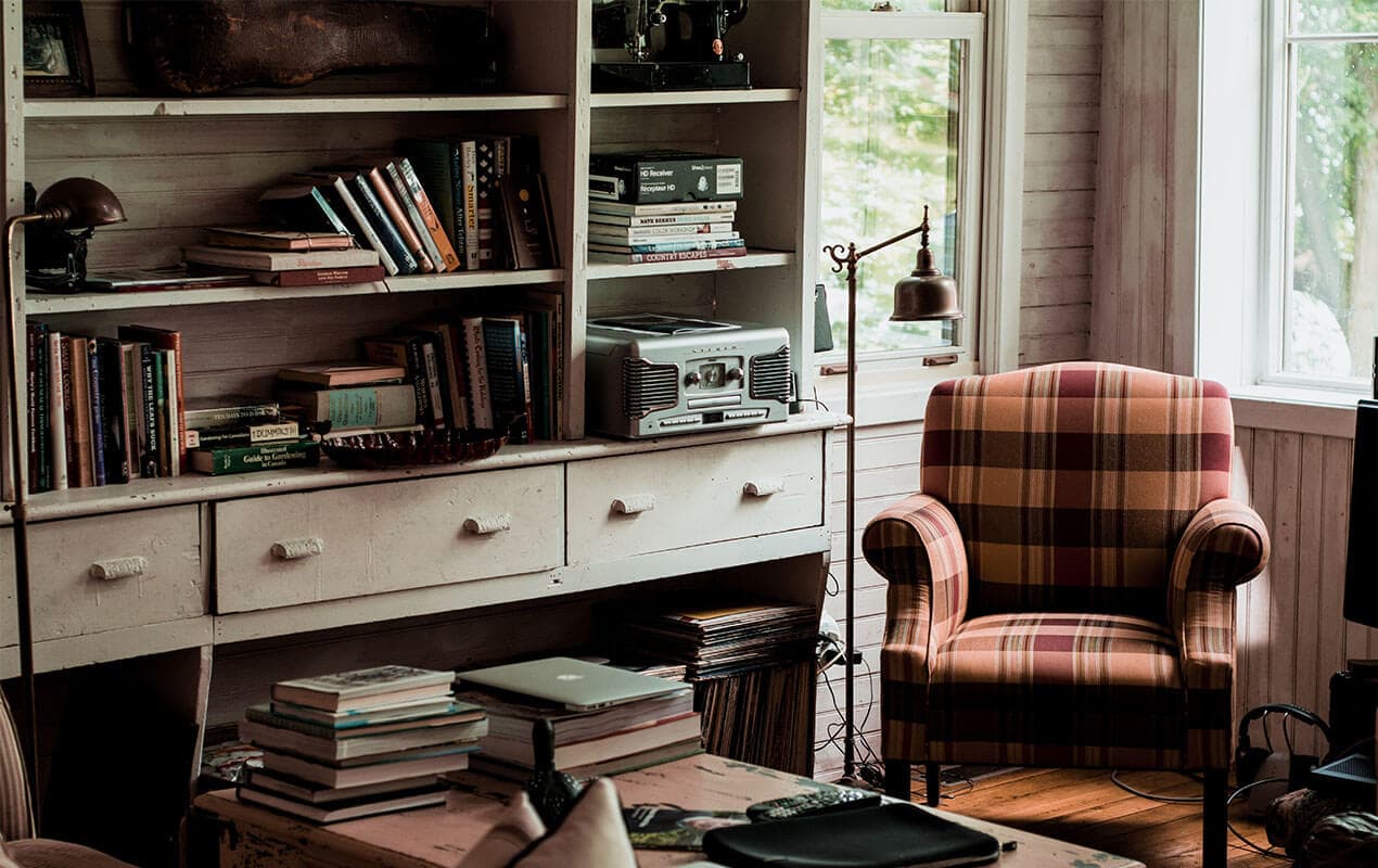 Vintage interior decor with a chair and book shelf
