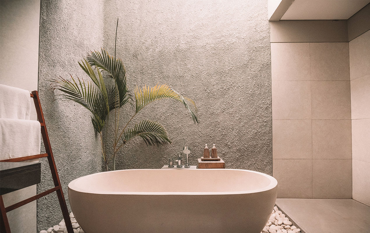 Stand alone bath with a floor plant