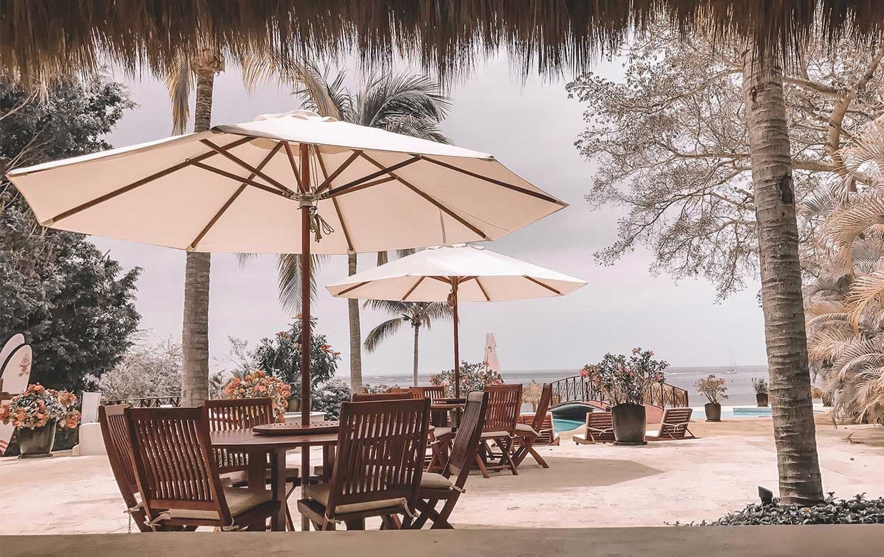 Beach with sand and furniture by DeCasa Collections
