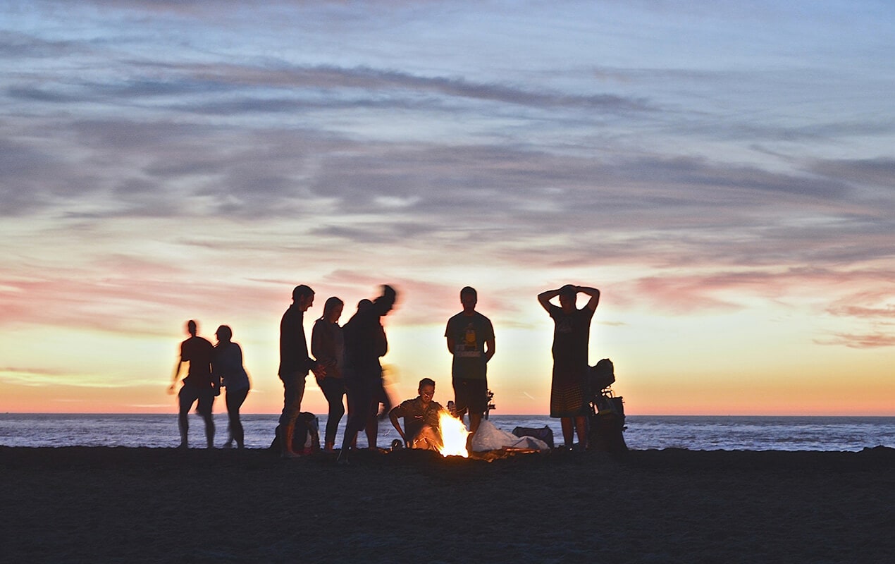 Friends gathering on the beach for a BBQ
