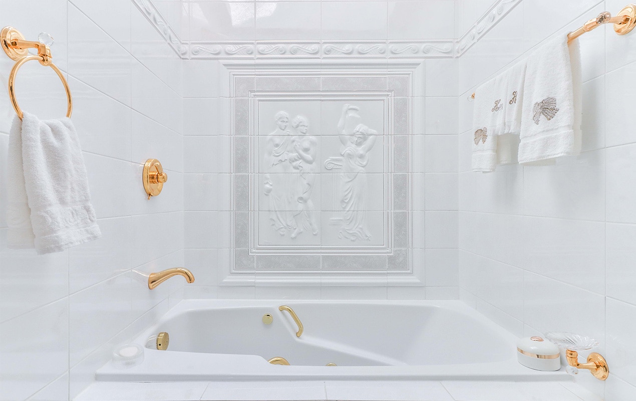 White bathroom decor with copper fixtures