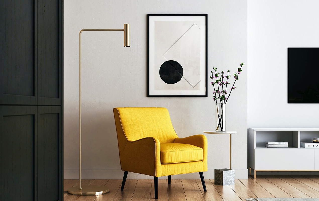 Living room interior with a tall think lamp and yellow chair.