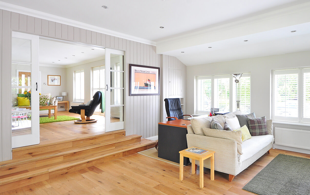 Reclaimed light wood flooring, white living room design