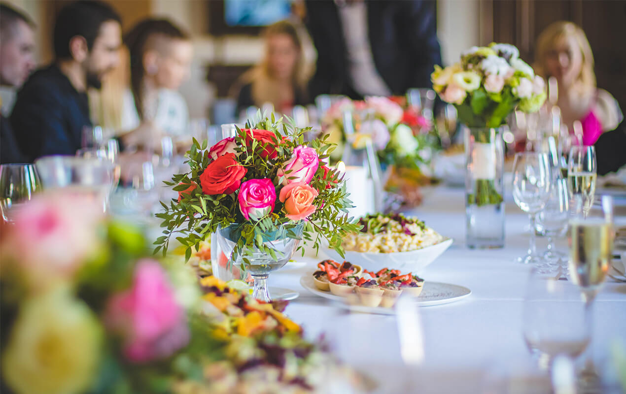 Dining table with flowers and food