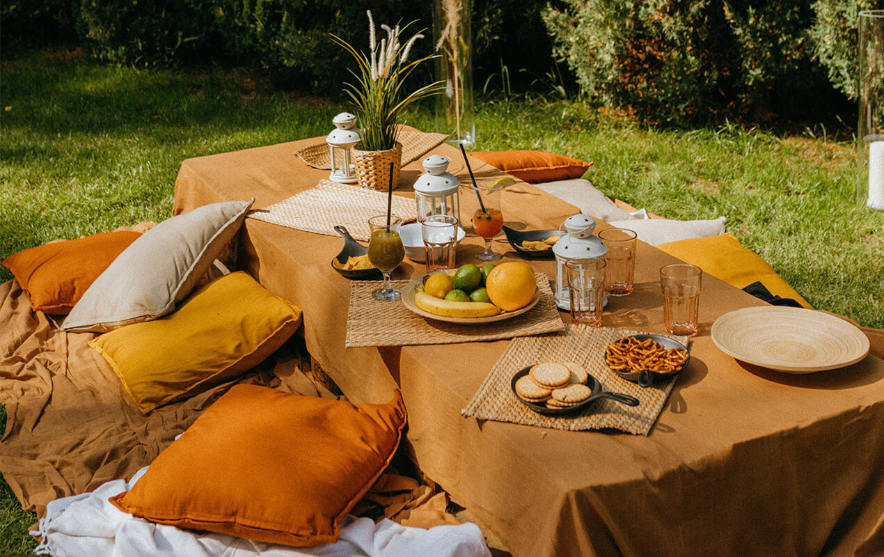 Outdoor dining table with fruit and wicker placemats