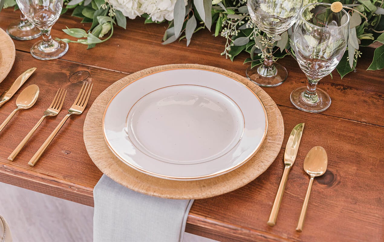 Table decor with gold serveware and biophilic centrepiece