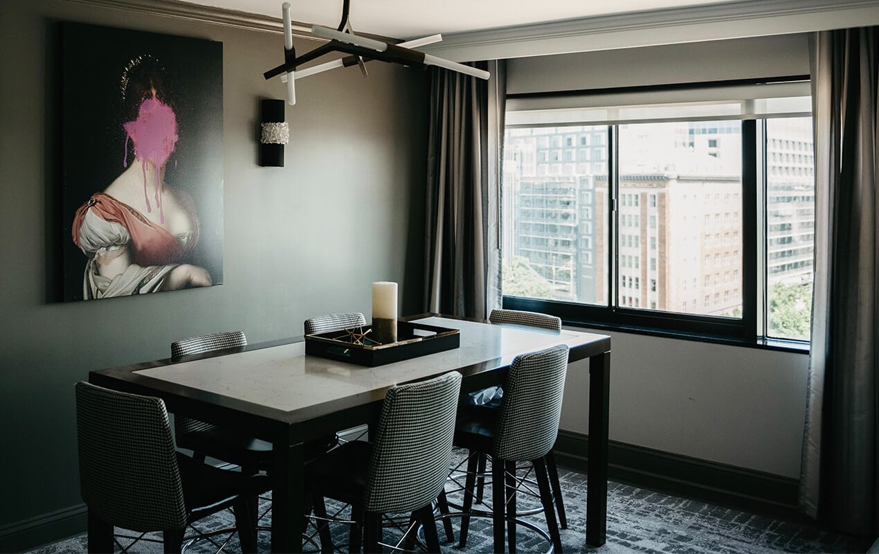 Home interior with table, chairs, and wall art