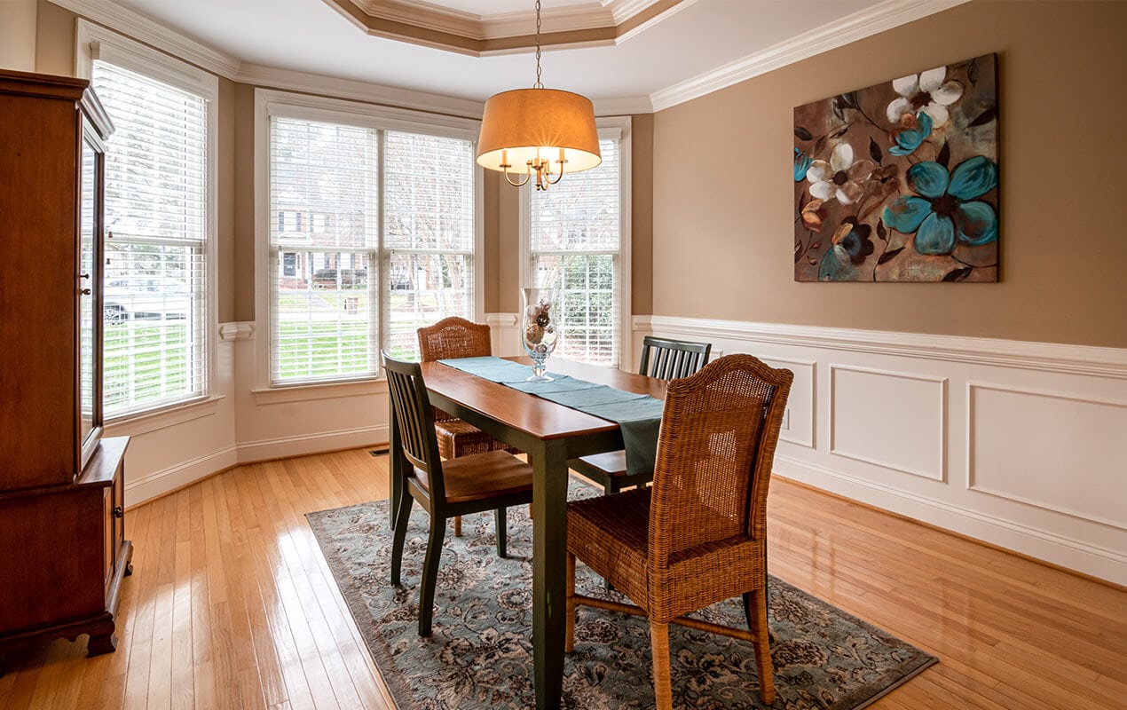 Dining room interior with white wood paneling