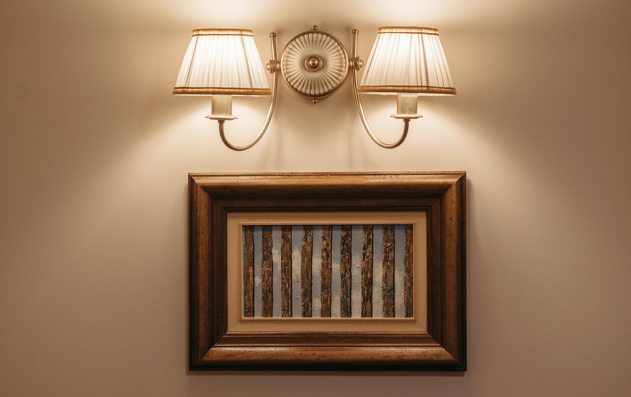 Home interior with framed art and wall lamps