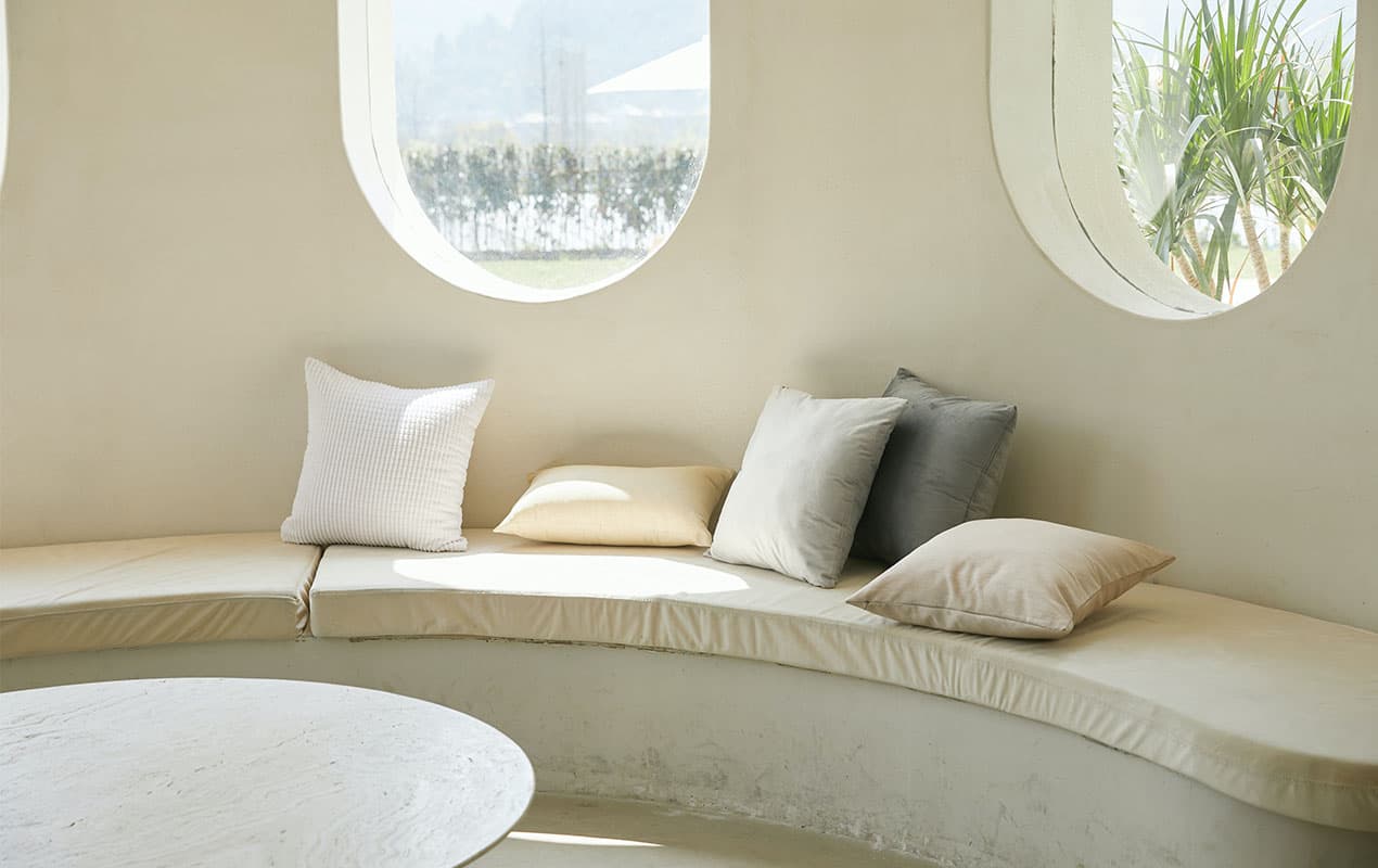 Window seat in front of oval windows