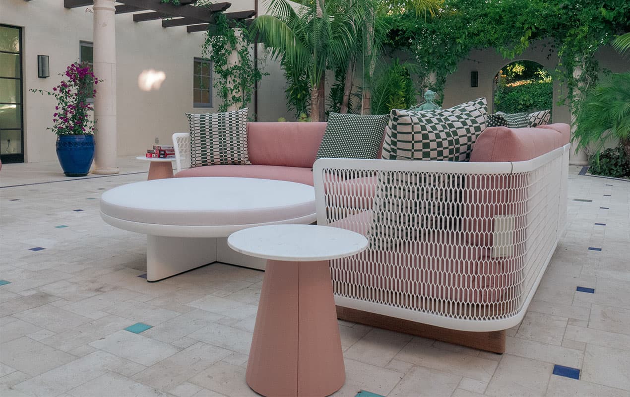 Outdoor furniture with pink cushioning and patterned cushions