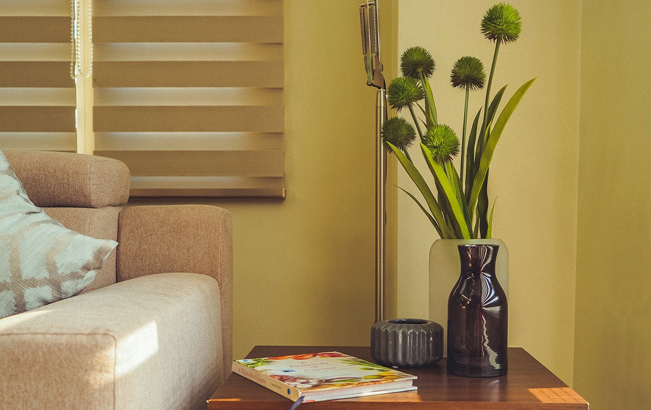 A vase with greenery and books