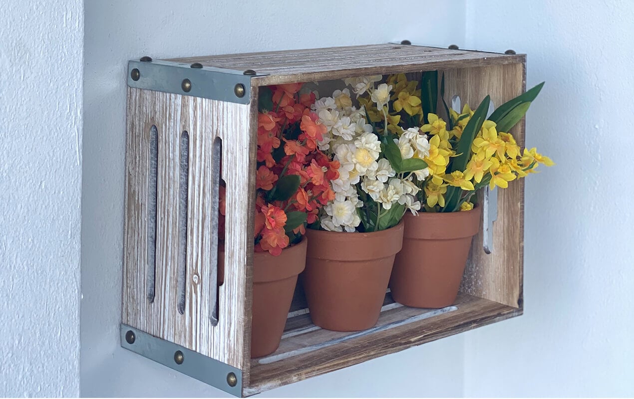 Wall crate with flower pots in