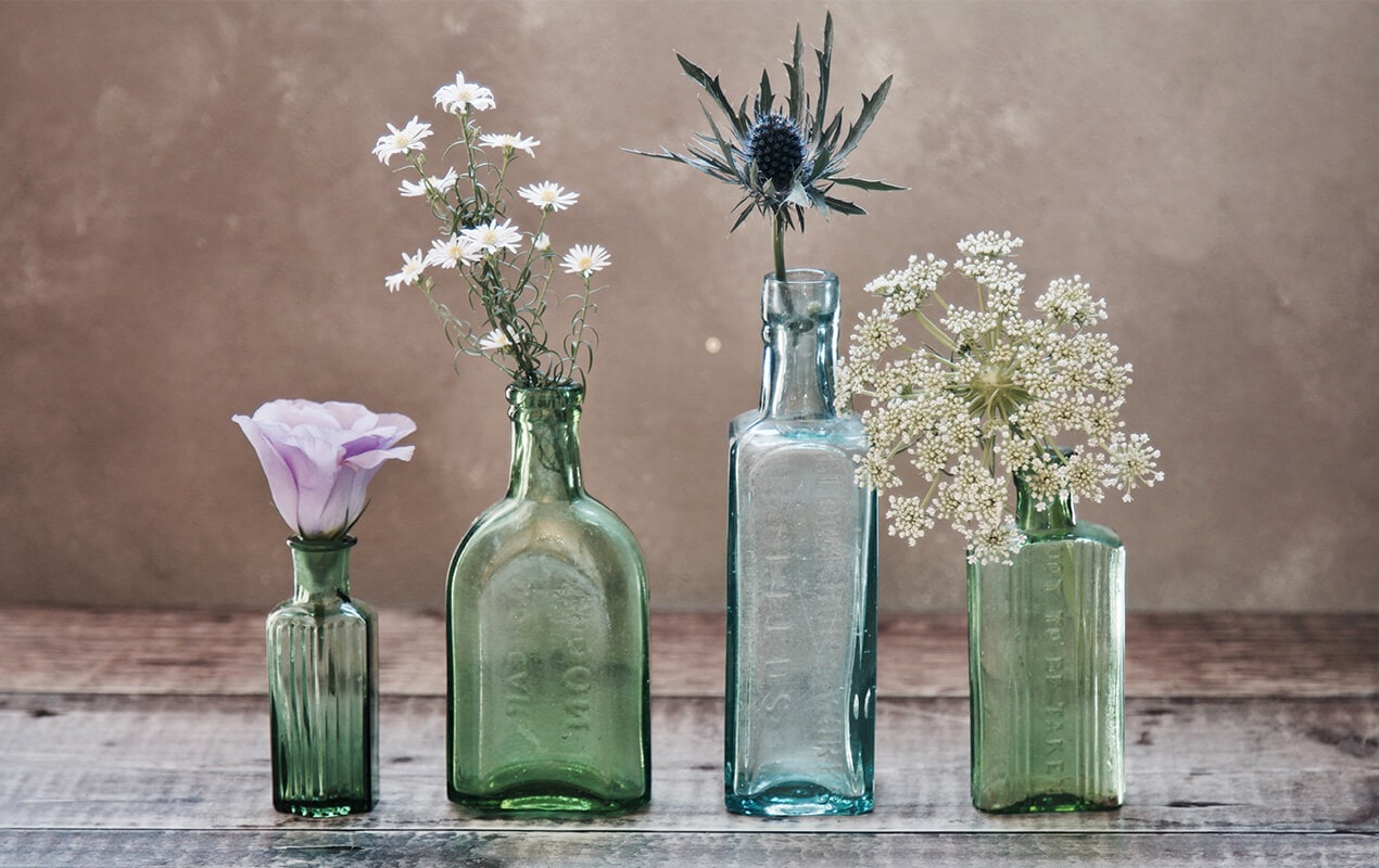 Glass bottles with flowers in