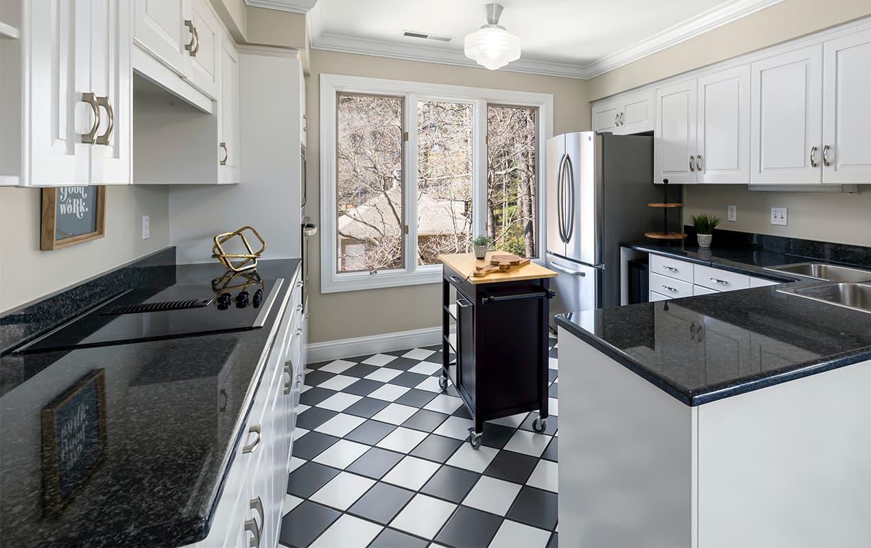 Black and white kitchen with checkered flooring