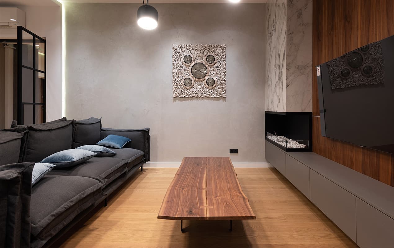 Small interior With black sofa and wood coffee table