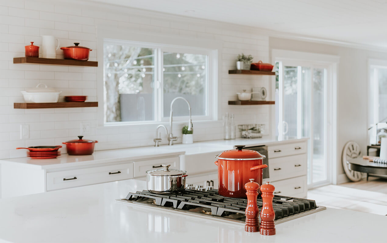 White kitchen interior with pops of color (red)