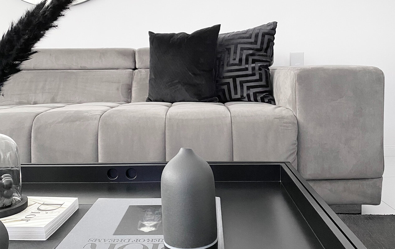 Chalk grey suede sofa with a black wood coffee table