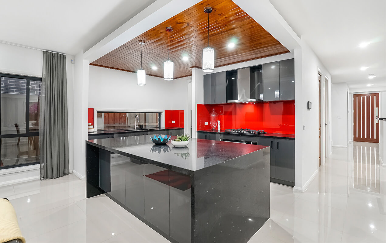 White kitchen interior with a red backsplash