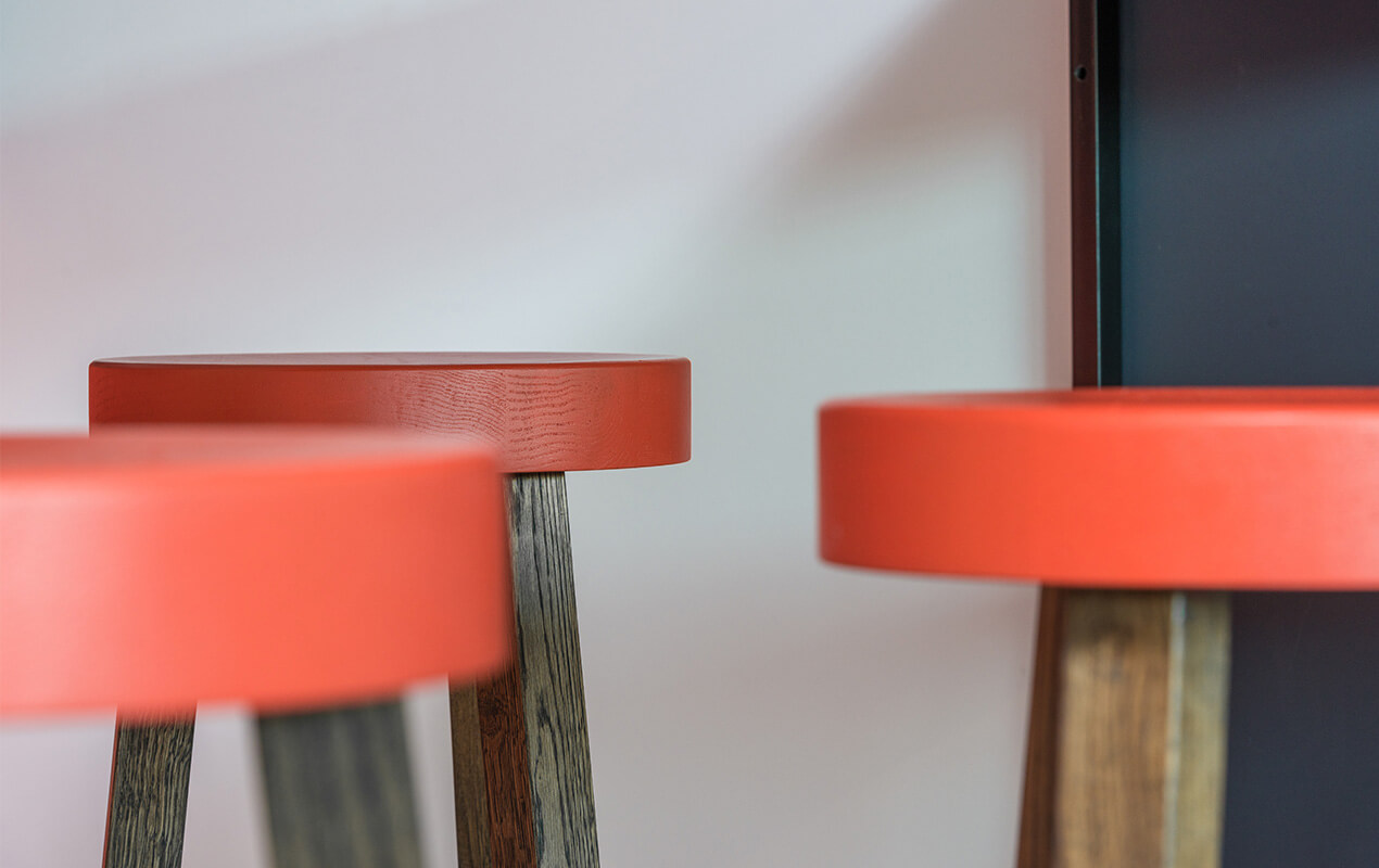 Red stools with a white background wall
