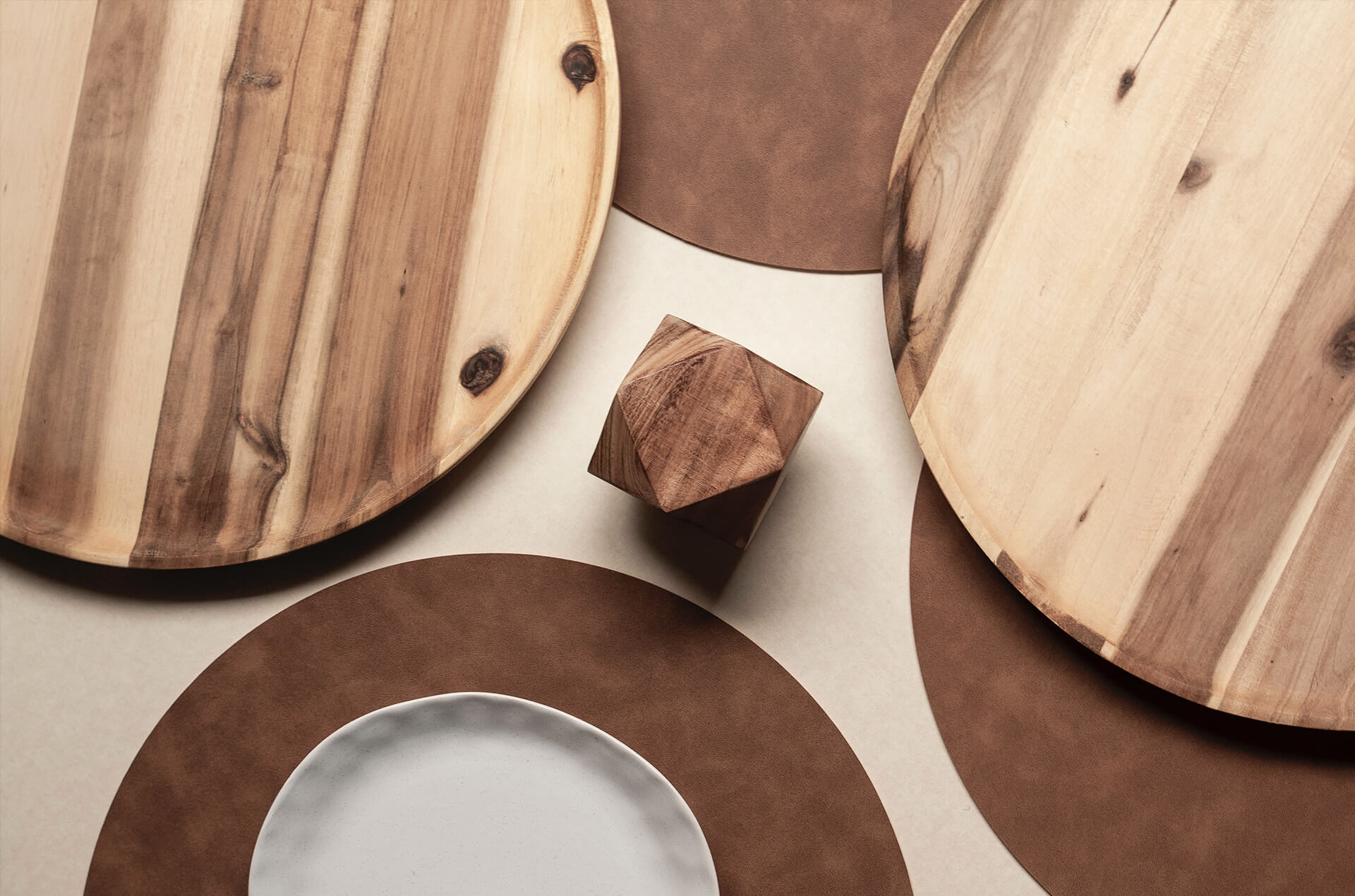 Round trays and a bowl on placemats