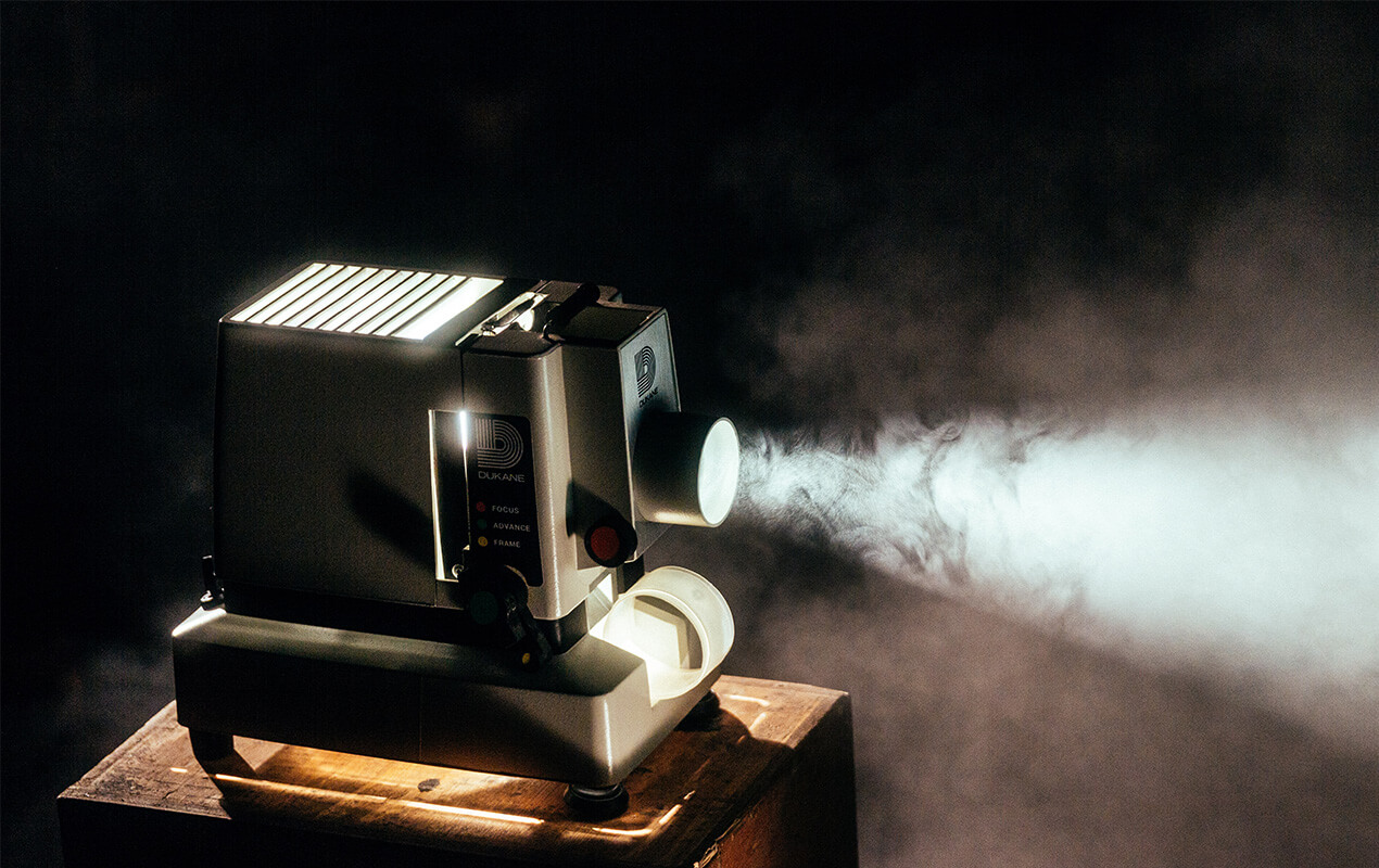 A projector playing film in a dark room