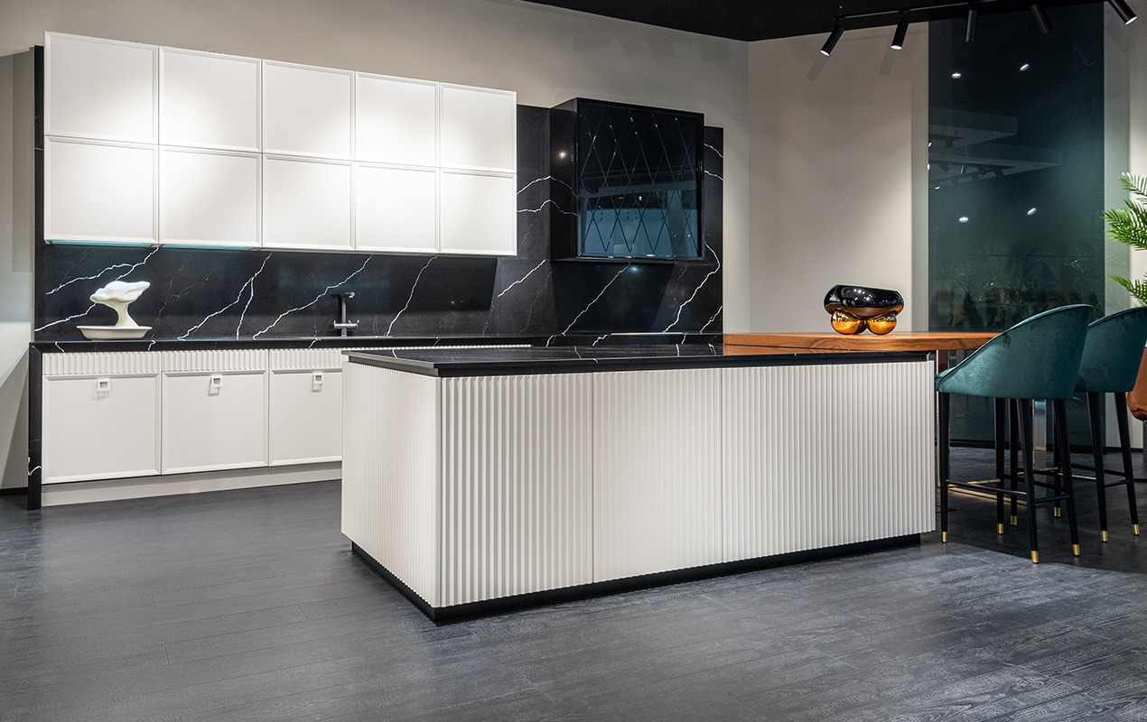 White paneled interior with gray flooring and wooden table by DeCasa Collections