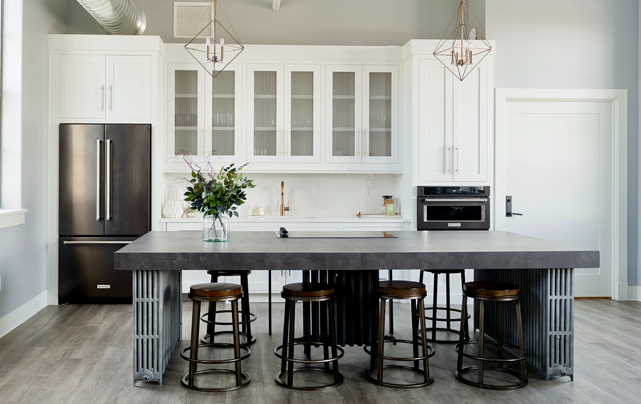 White kitchen interior with wood stools by DeCasa Collections