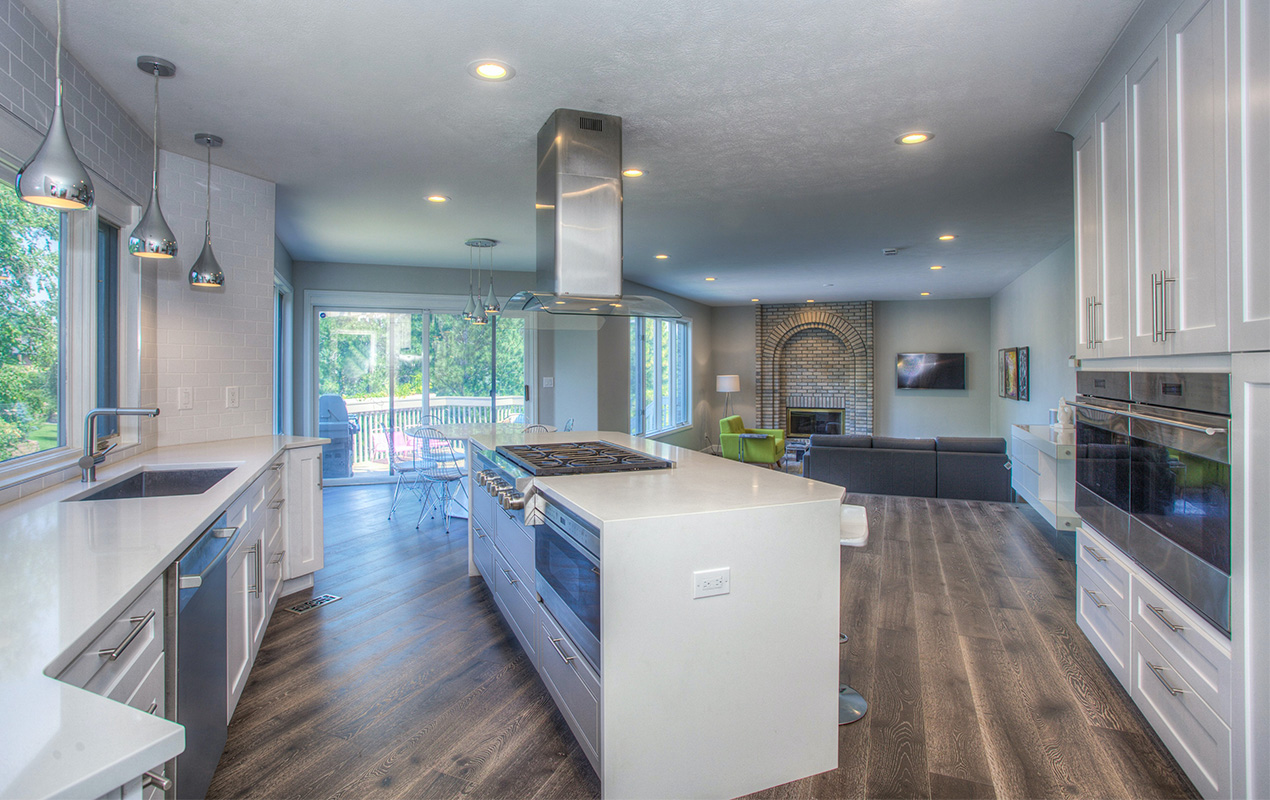 White rectangular kitchen island with stove by DeCas Collections