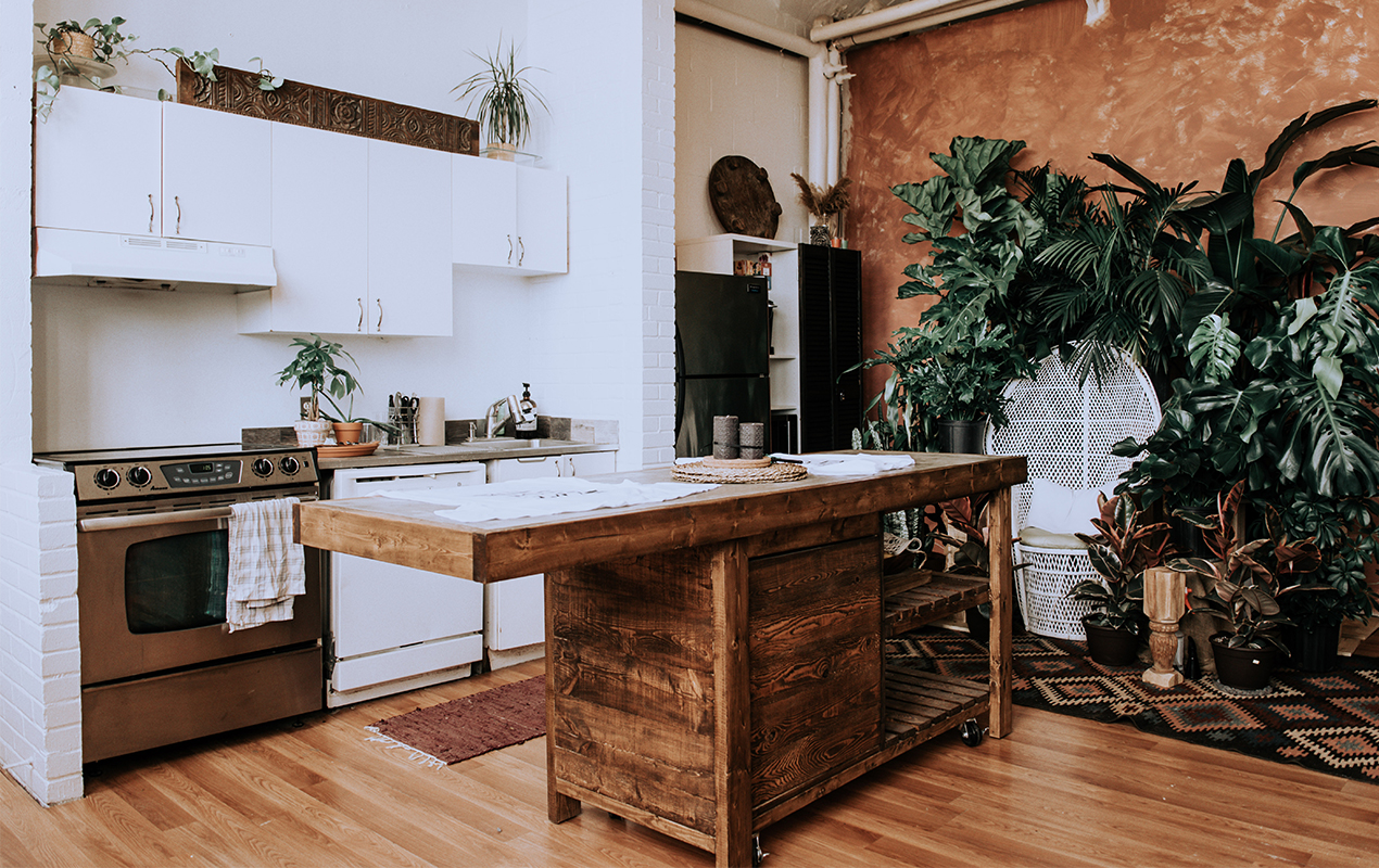 Wooden kitchen interior with an island by DeCasa Collections