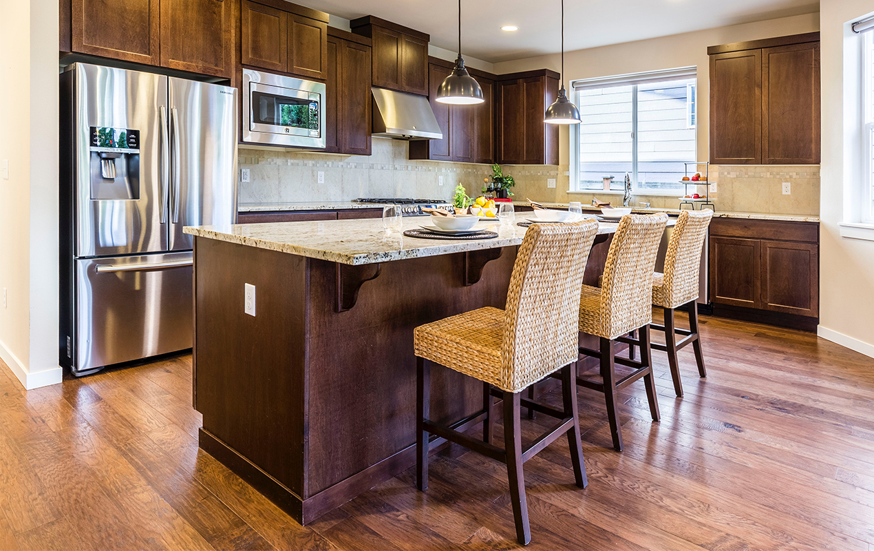 Rustic kitchen island with seating by DeCasa Collections