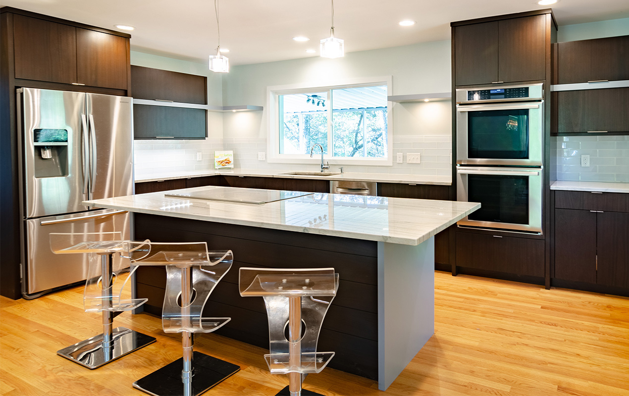 White kitchen with wood flooring by DeCasa Collections