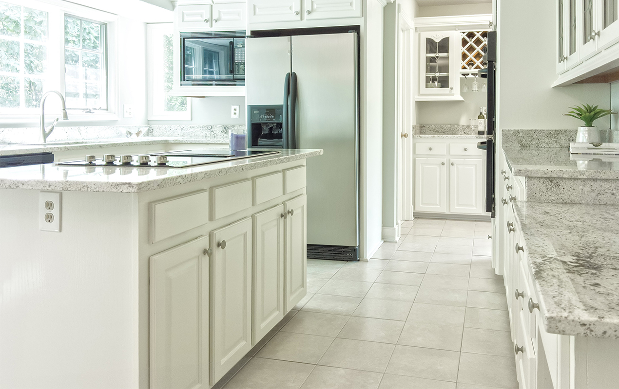 White wooden kitchen island cabinets by DeCasa Collections