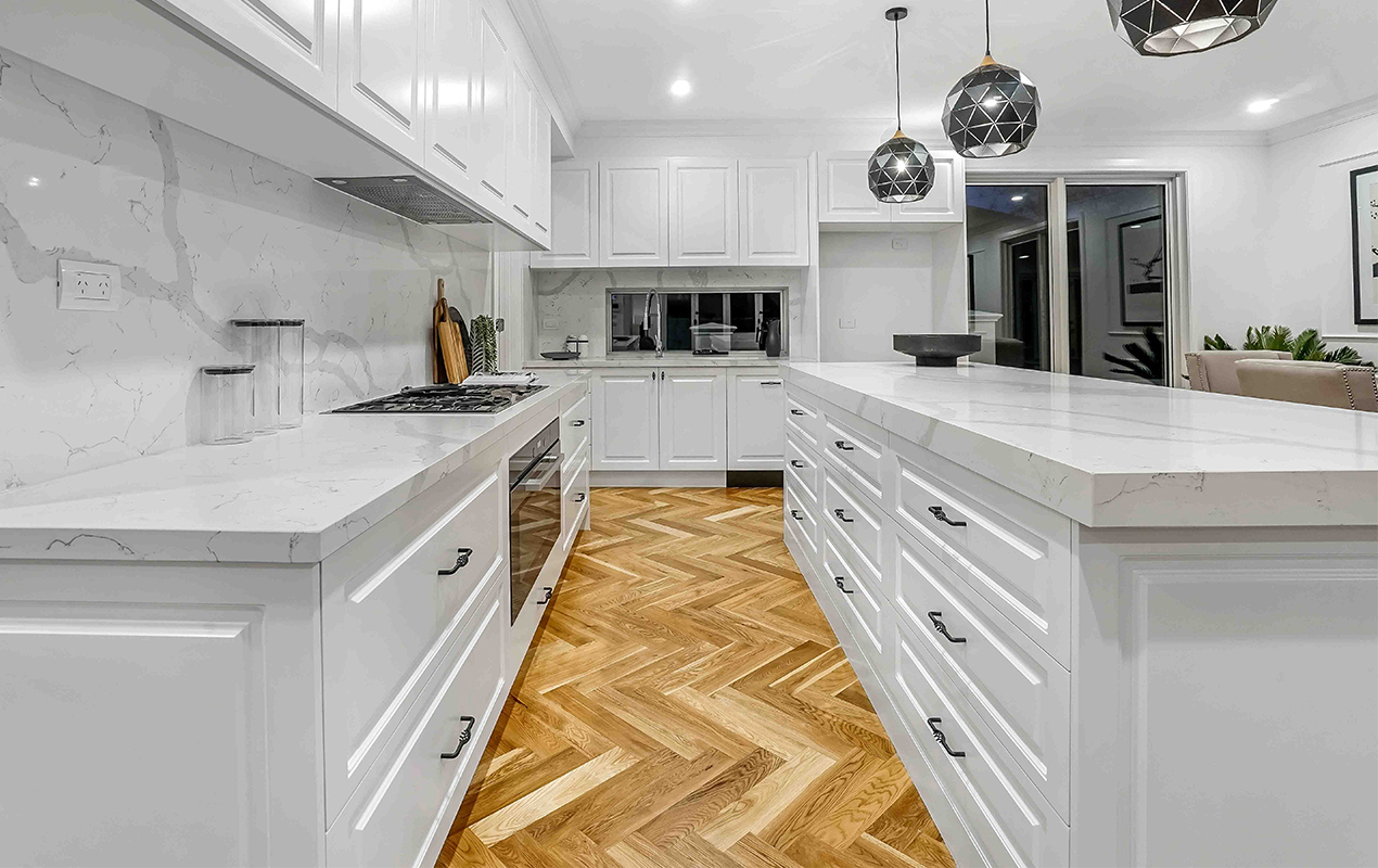 White interior with herringbone flooring by DeCasa Collections