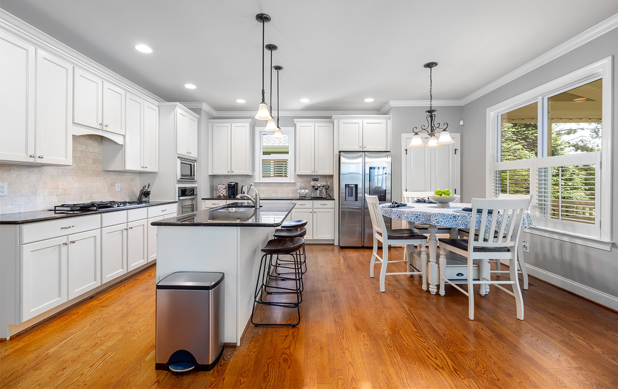 Kitchen interior with orange wood flooring by DeCasa Collections