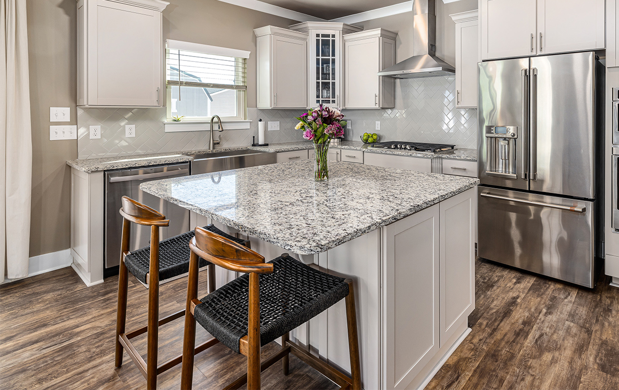 Kitchen with industrial features and rattan wood seating by DeCasa Collections