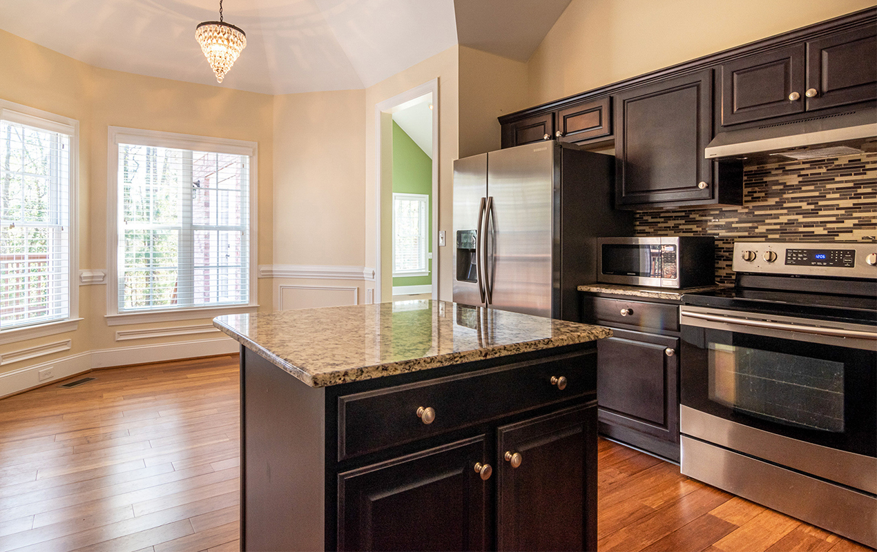 Black wood kitchen island cabinets by DeCasa Collections