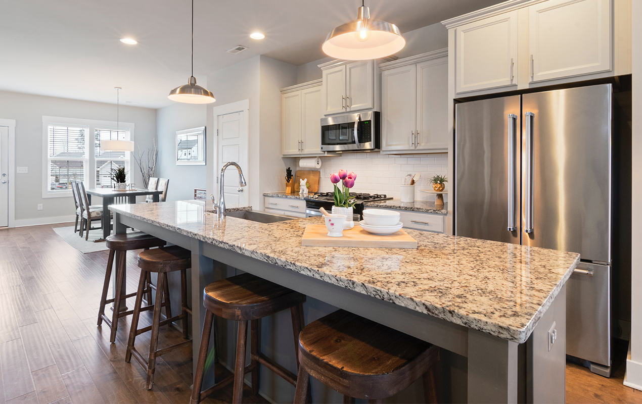 Gray island with marble countertop by DeCasa Collections