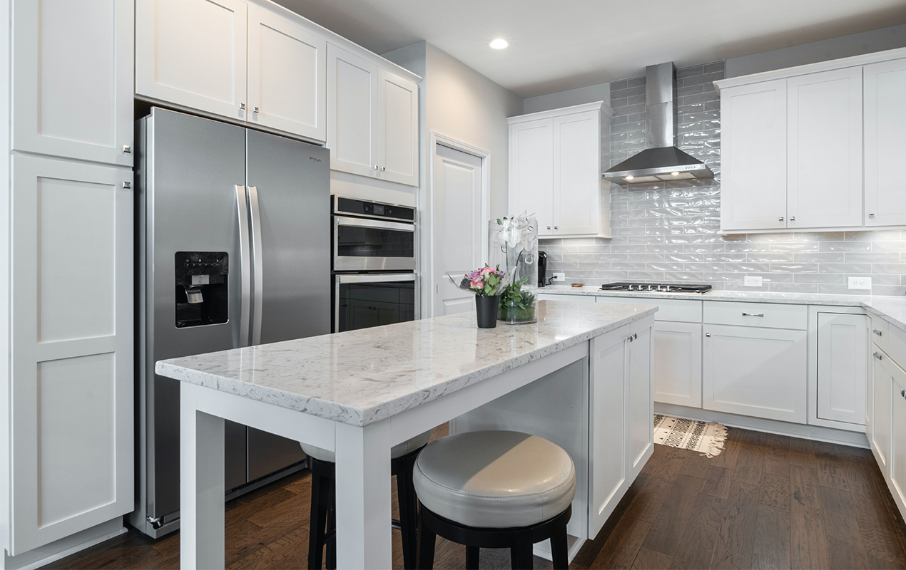 Kitchen island with storage cabinets and seating by DeCasa Collections