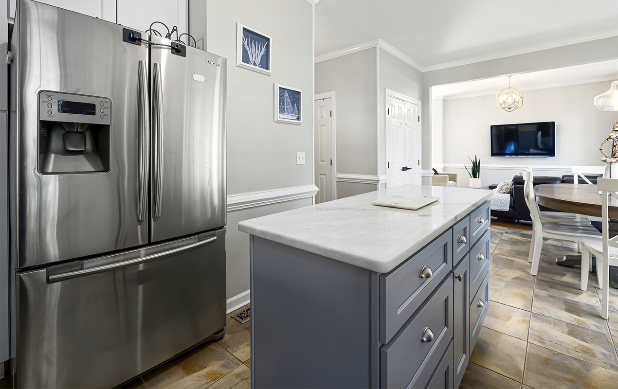 Narrow kitchen island with cabinets by DeCasa Collections