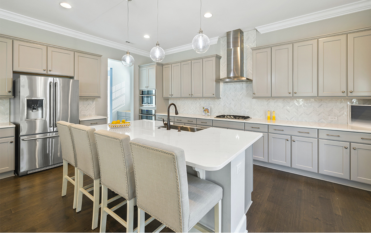 White kitchen with high-back chairs by DeCasa Collections