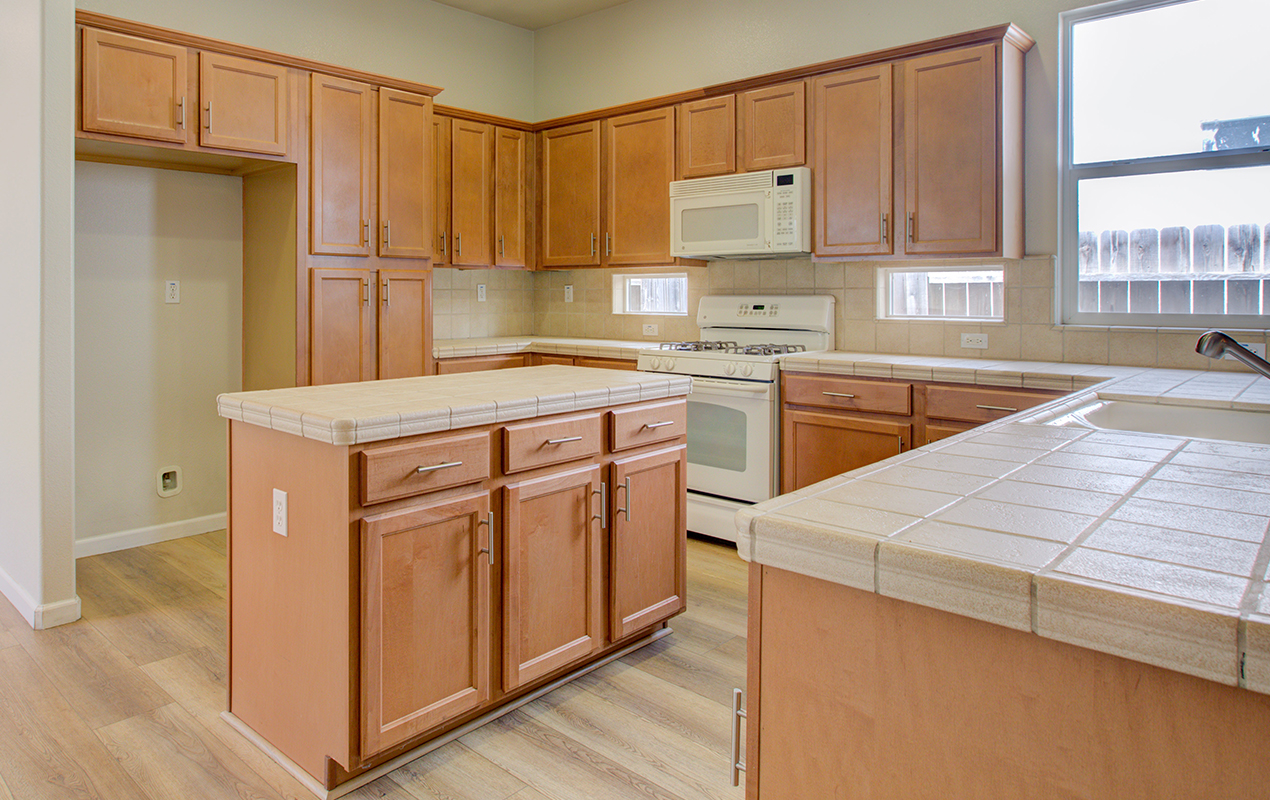 Rustic kitchen island with internal cabinets by DeCasa Collections