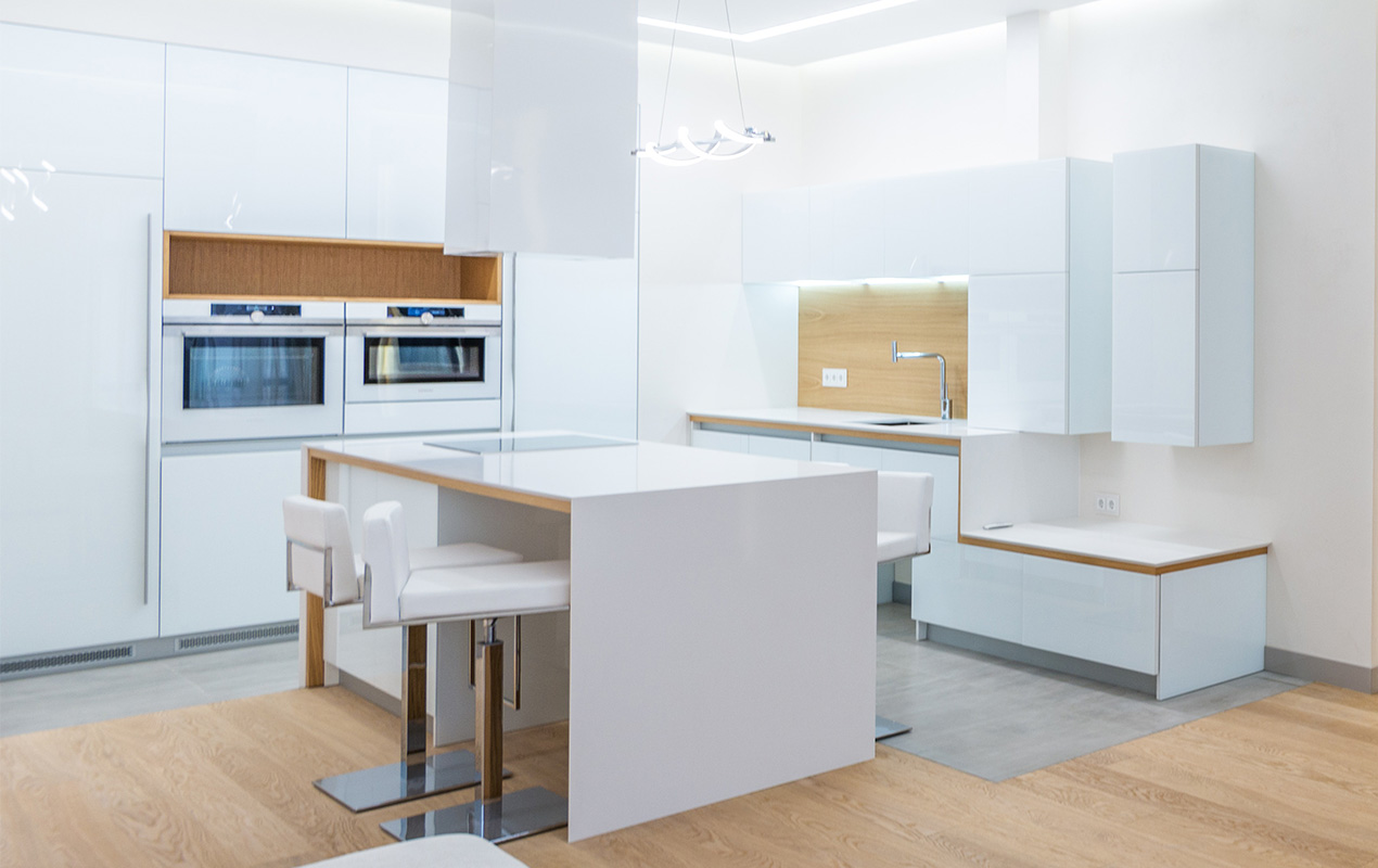 All-white kitchen with induction stove by DeCasa Collections