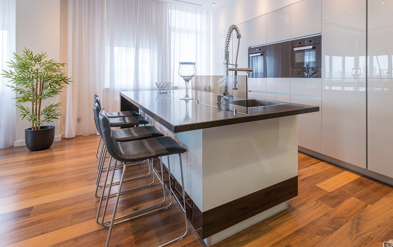 Black and white kitchen island with leather seating by DeCasa Collections