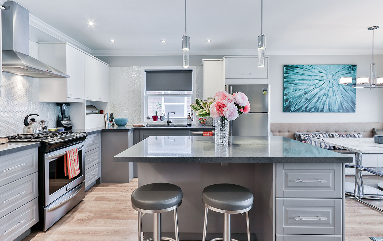 Gray kitchen island with storage drawers and gray seating by DeCasa Collections